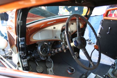 1998 Ford Crown Victoria - The dashboard of a vintage car features a central gauge cluster and a prominent steering wheel.