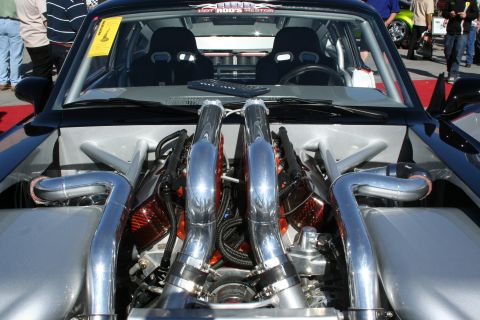 1998 Ford Crown Victoria - Engine bay of a highly modified car, twin turbochargers and custom exhaust piping.