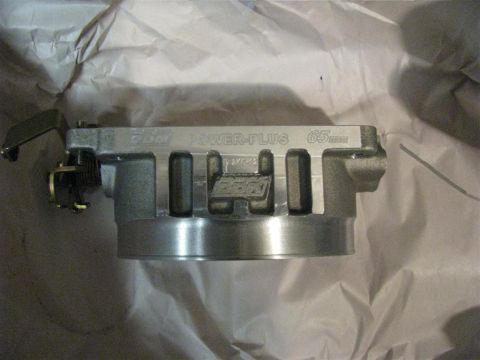 2003 Mercury Marauder - A close-up view of a BBK Power-Plus 65mm throttle body, likely a new part before installation.