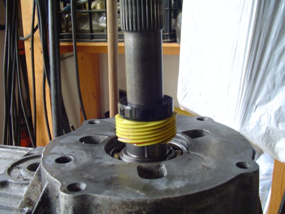 Mainshaft with yellow threaded nut seated on transfer case housing