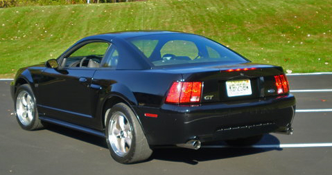 2002 Ford Mustang - Rear view of a black 2002 Ford Mustang GT coupe with a GT badge and a license plate.