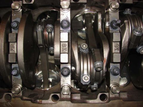 2007 Ford Mustang - Close-up view of an engine's crankshaft and connecting rods, showing internal mechanical components.