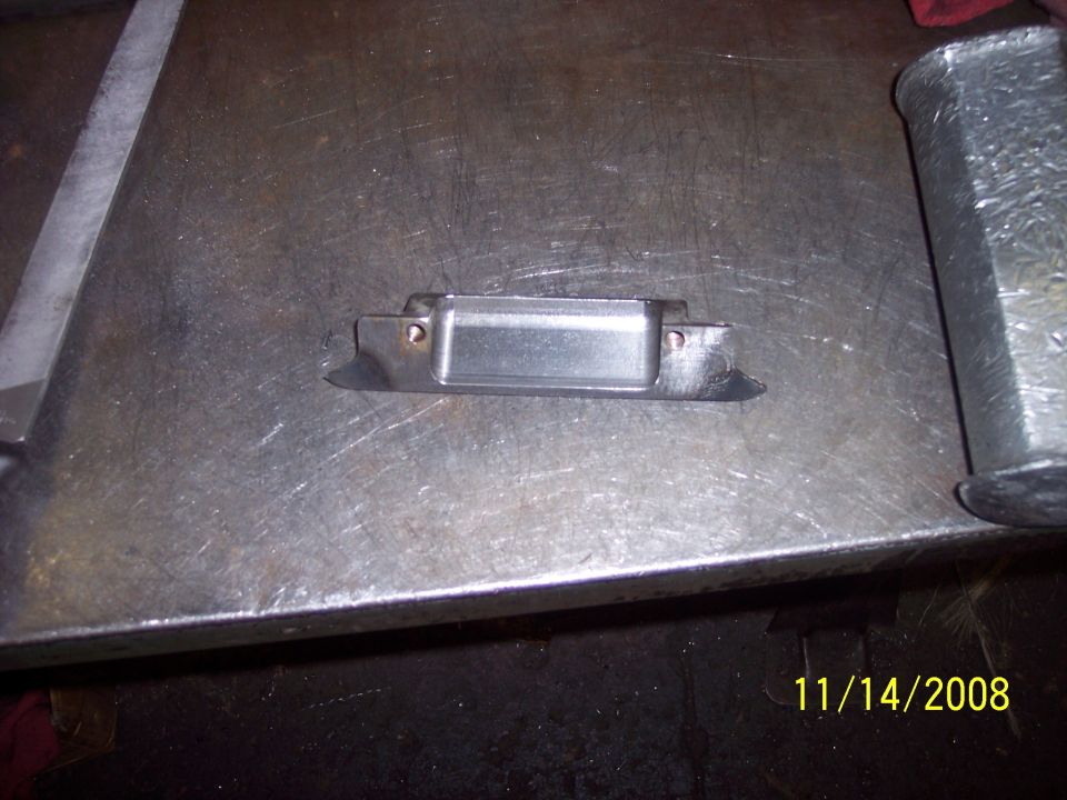 Metal bracket with rectangular opening on a workbench