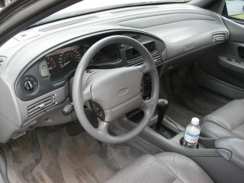 1993 Ford Taurus - The interior of a 1993 Ford Taurus, gray upholstery and dashboard details.