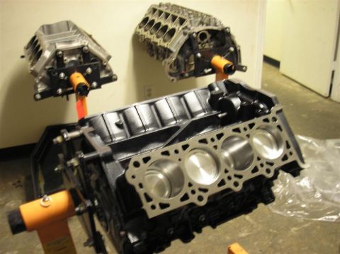 2007 Ford Mustang - Multiple engine blocks are displayed on orange stands, ready for assembly or repair.