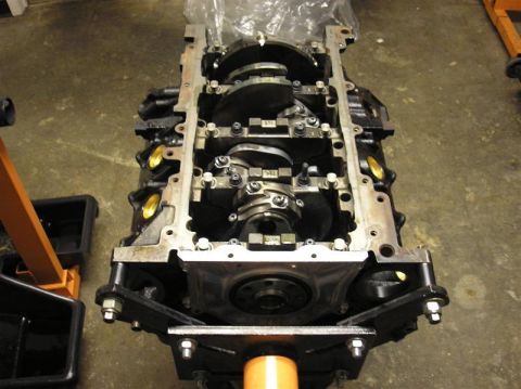 2007 Ford Mustang - Engine block assembly with crankshaft and connecting rods exposed, mounted on an engine stand.