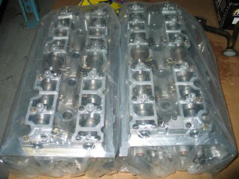2007 Ford Mustang - A pair of engine cylinder heads are shown, wrapped in protective plastic packaging.