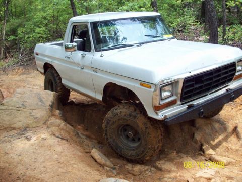1979 Ford Bronco — White 1979 Ford F-150 pickup truck off-roading