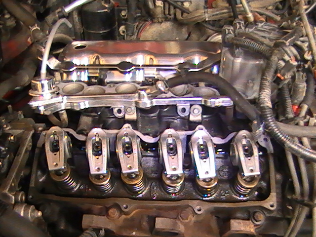 Close-up of engine valve train with rocker arms and springs visible