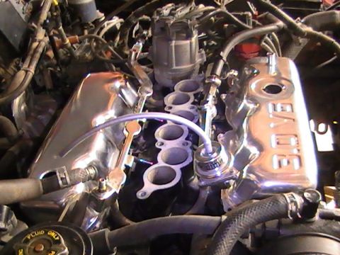 1990 Ford Probe - Close-up of a V6 engine bay chrome valve covers and intake manifold.