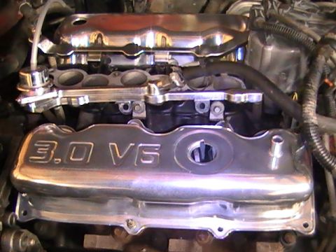 1990 Ford Probe - Close-up view of a chrome 3.0 V6 engine cover and associated components.
