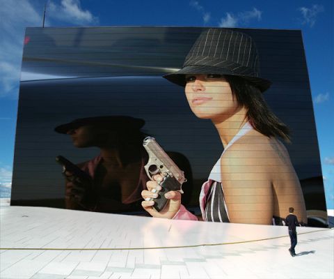 2003 Mercury Marauder - A woman holding a gun is reflected in the tinted rear window of a car, with a small man visible in the foreground.