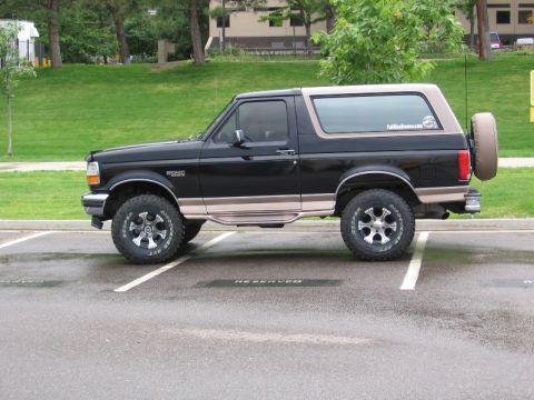 1996 Ford Bronco - This 1996 Ford Bronco features a two-tone paint scheme and is equipped with off-road tires and wheels.