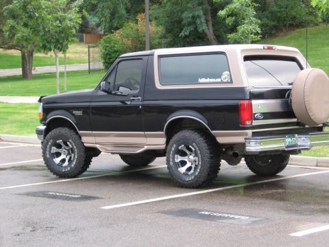 1996 Ford Bronco - This 1996 Ford Bronco is parked in a lot with a spare tire mounted on the rear.