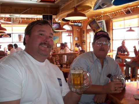 1996 Ford Bronco - Two men enjoy drinks at a table in a casual restaurant setting.