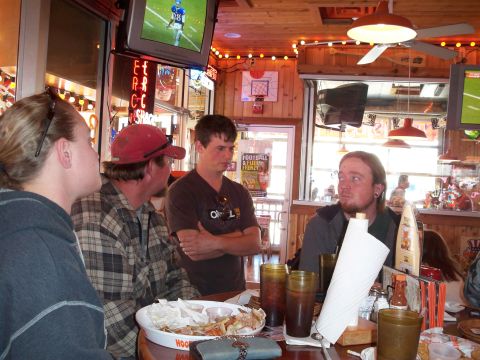 1996 Ford Bronco - Friends gather at a restaurant, watching sports on TV while enjoying a meal.