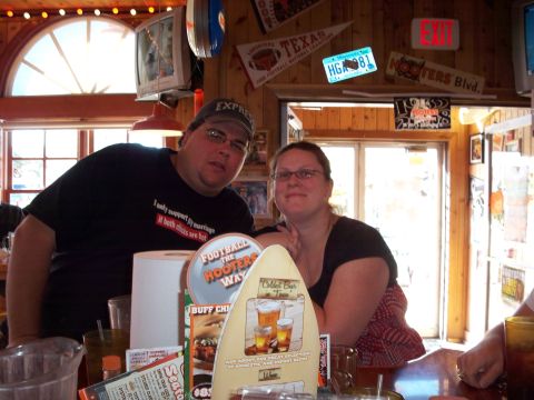 1996 Ford Bronco - Two people are pictured at a bar, with various decorations visible on the wall behind them.