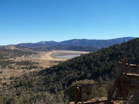 1990 Ford Bronco - Panoramic view of a valley town and dry lake bed under a clear blue sky.