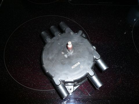 1993 Ford Probe - A Bosch distributor cap is shown, a key component for igniting fuel in an engine.