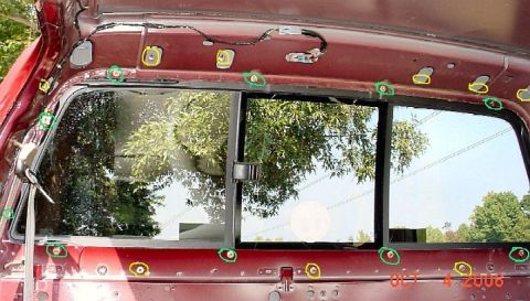 2007 Ford Mustang - The rear window frame of a red vehicle shows exposed bolts and wiring, with a date stamp of OCT 4 2006.