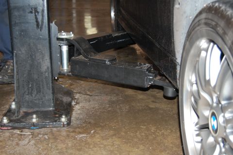 2002 BMW M3 - Close-up of a BMW wheel and rocker panel being serviced on a car lift.