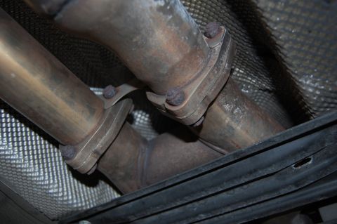 2002 BMW M3 - The underside of a vehicle shows a section of the exhaust system with two pipes merging together.