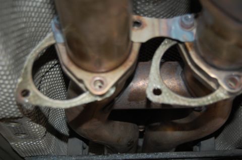 2002 BMW M3 - Close-up view of exhaust manifold gaskets on the underside of a vehicle.