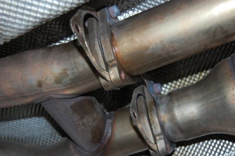 2002 BMW M3 - Exhaust system components, likely catalytic converter flanges, shown from underneath.