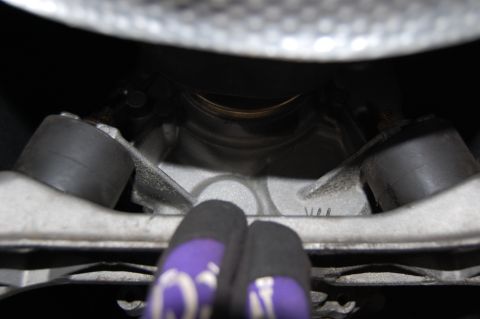 2002 BMW M3 - Close-up view of an engine mount, showing some stamped markings including 'W4'.