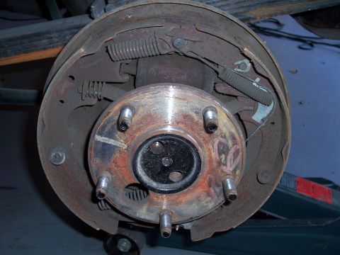 1978 Ford Bronco - Close-up view of a vehicle's rear drum brake assembly, showing internal components and the wheel hub.