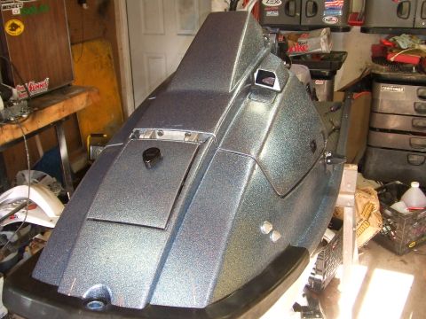 1998 Kawasaki JH1100-A4 1100 ZXi - A jet ski with a metallic blue finish is parked in a garage, supported by a stand.