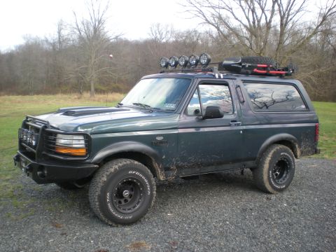 1993 Ford Bronco - This 1993 Ford Bronco is equipped for off-road adventures with a roof rack, spare tire, and auxiliary lighting.