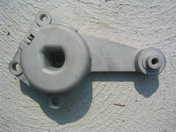 Photo of a cast aluminum accessory bracket against a stucco wall