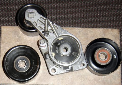 2007 Ford Mustang - Photograph of a Ford belt tensioner and idler pulleys, not a technical document.