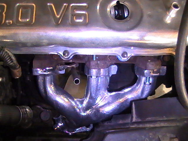 Chrome exhaust manifold on a 3.0 V6 engine.