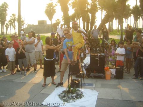 1968 Ford Mustang - Photograph of a Venice Beach street performance, not a technical document.