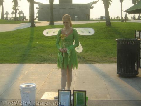 1968 Ford Mustang - photograph of a costumed street performer at a beach park, not a technical document.