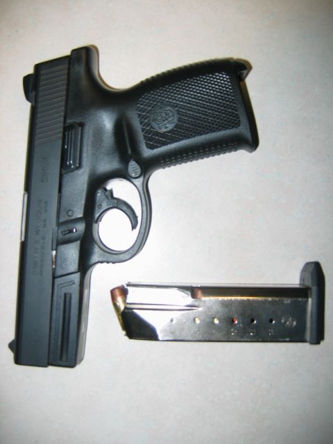 1992 Ford Mustang - A black semi-automatic pistol is shown with its magazine removed.