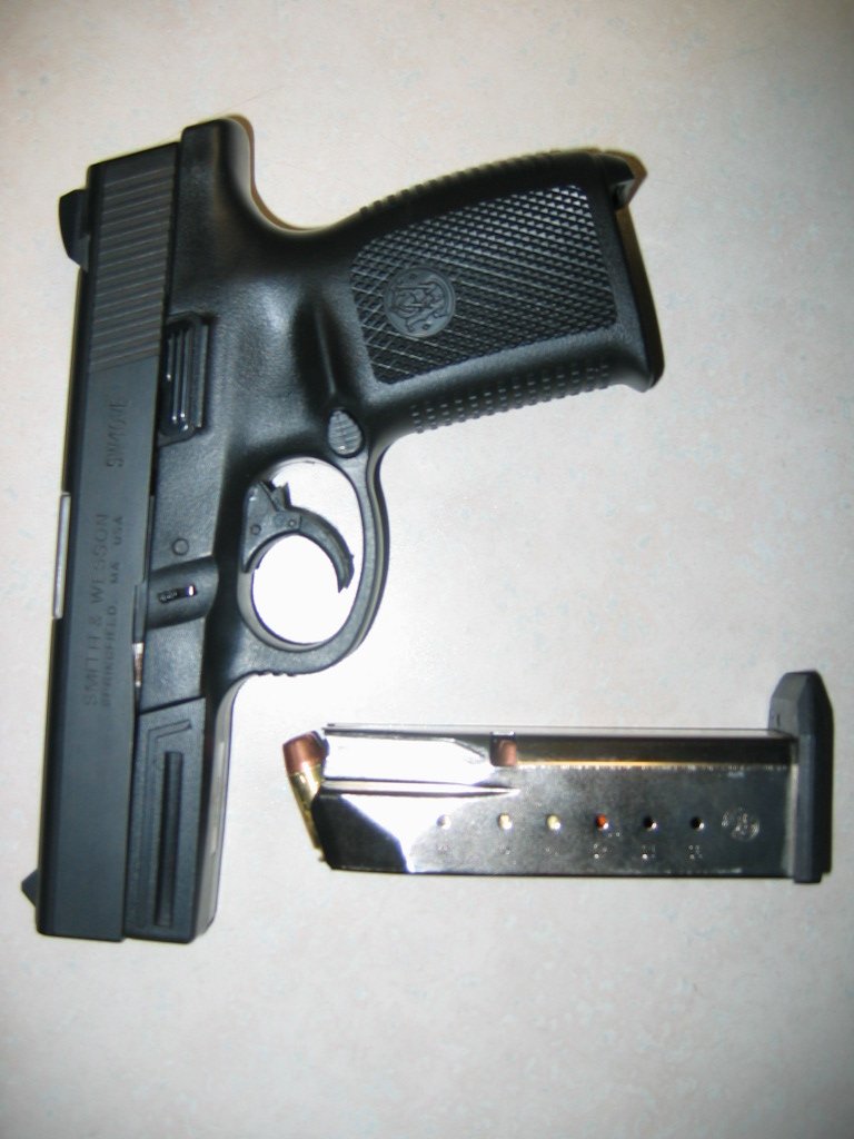Black pistol with detached magazine