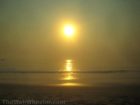 1968 Ford Mustang - photograph of a hazy sunrise over the ocean, not a technical document.
