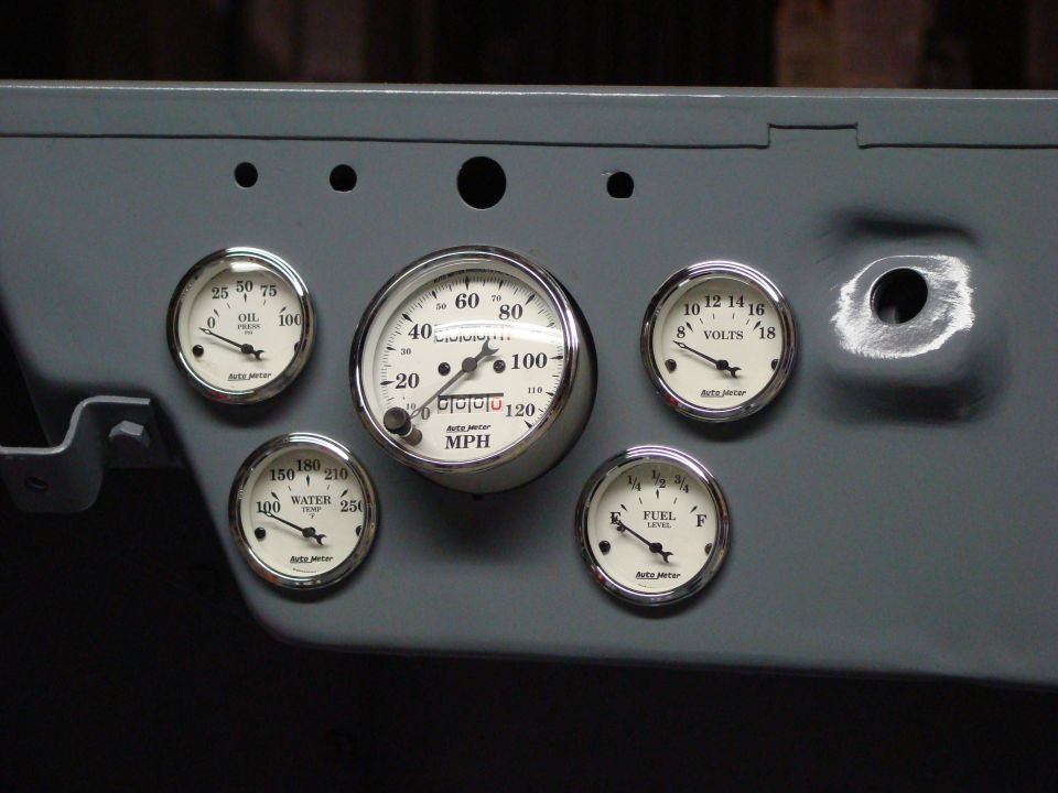 Dashboard with five Auto Meter gauges including speedometer, oil pressure, water temp, fuel level, and voltage.