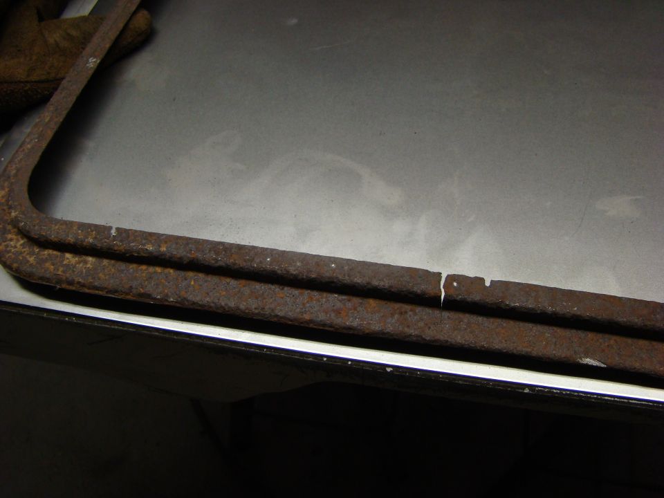 Close-up of two rusty, curved metal bars, one with a break.