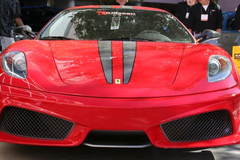 1998 Ford Crown Victoria - Photograph of the front end of a red Ferrari F430 with a black center stripe, not a technical document.