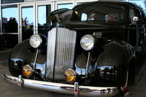 1998 Ford Crown Victoria - Photograph of the chrome grille and headlamps of a vintage Packard, not a technical document.