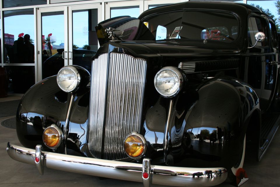Front grille and headlights of a black 1930s Packard sedan