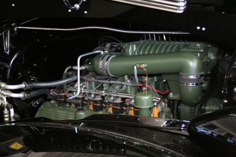1998 Ford Crown Victoria - Photograph of a detailed green engine in a classic car engine bay, not a diagram.