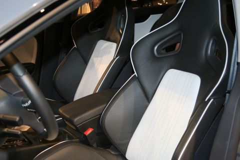 1998 Ford Crown Victoria - The interior features sporty bucket seats with contrasting white piping and a textured fabric panel.