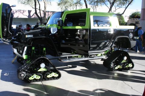 1998 Ford Crown Victoria - This modified Hummer H2 features tracks for off-road capability and custom paint.