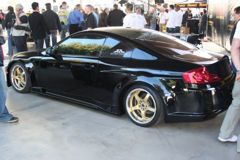 1998 Ford Crown Victoria - A black coupe with distinctive gold rims and a custom body kit is viewed from the rear three-quarter angle.