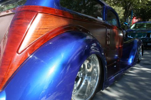 1998 Ford Crown Victoria - A custom hot rod features a unique combination of blue metallic paint and wood paneling on its body.